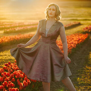 A photo of my lovely wife, Jennie, in her handmade sparkle dress, set against a vast tulip field